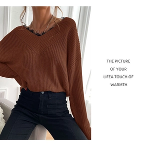 Detail view of V-neck knitted sweater with delicate black lace stitching in dark brown