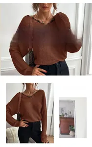 Detail of V-neck knitted sweater with elegant black lace trim and thick ribbed texture