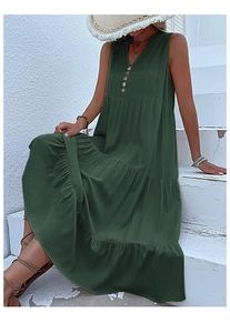 Outdoor shot of sleeveless dark green V-neck maxi dress with tiered skirt design