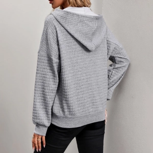 Women's oversized grey waffle knit hoodie with long sleeves and loose fit textured style