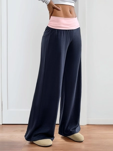 Detail of high-waist wide-leg pants in navy and pink contrast colors for lounge or yoga