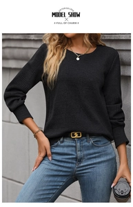 Detailed close-up showing the 3D geometric texture and ribbed cuffs of the black sweatshirt