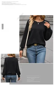 Detail of black textured long sleeve sweatshirt with crew neck and ribbed cuffs