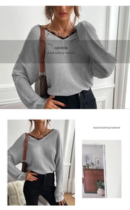 Detail of grey V-neck knit sweater featuring delicate black lace trim at the neckline