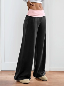 Detail of high-waist wide-leg pants in black and pink with professional soft drape finish
