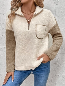 Detail of soft sherpa fleece patchwork with 1/4 zipper and chest pocket on sweater