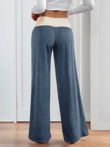 Detail view of navy blue wide-leg lounge pants with a beige elastic waistband for comfort