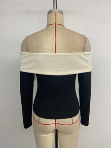 Detail of off-shoulder long sleeve top with contrast bow trim and slim fit design