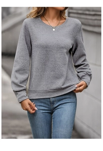 Detail showing grey crewneck sweatshirt with textured herringbone pattern fabric