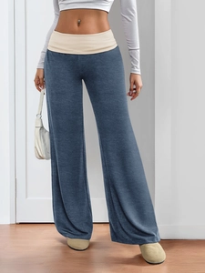 Detail view of wide-leg sweatpants featuring a stylish beige fold-over waistband design
