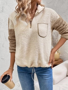 Detail view of female sherpa pullover with half-zip collar and adjustable drawstring hem
