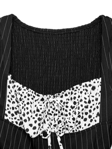 Detail of square neckline with smocked back, stripe patchwork and dalmatian print bow