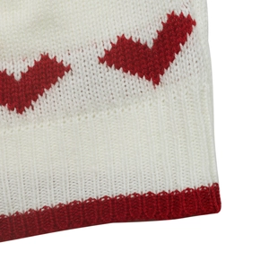 Macro view of white knit fabric with red jacquard heart and ribbed edge detail