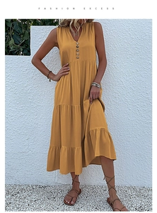 Detail of V-neck button closure on a mustard yellow tiered summer maxi dress