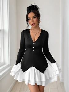 Detailed close-up of V-neck dress with white decorative buttons and contrasting hem