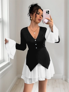 Detailed view of elegant V-neck dress featuring contrast splicing and white pleated hem