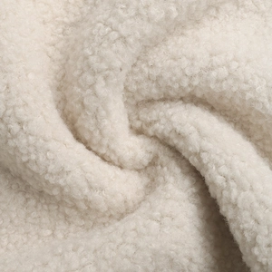 Macro shot of high-quality cream white sherpa fleece fabric showing soft curly texture