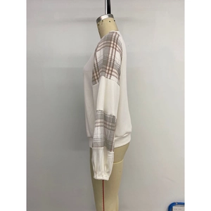 Women's white long sleeve sweatshirt with contrast plaid patchwork sleeves on a mannequin