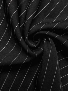 Detail of high-quality black pinstripe fabric with fine twill texture and soft drape