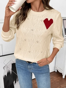 Detailed knit texture of off-white sweater with heart cutouts and red heart patch