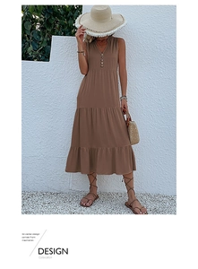Detail of a brown V-neck sleeveless tiered maxi dress with button accents in a resort style