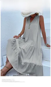 Detail of light grey V-neck maxi dress with tiered pleats and wooden buttons