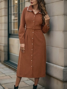 Close-up of caramel corduroy dress featuring elegant white lace collar and button details