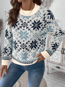 Detail of snowflake jacquard pattern and ribbed cuffs on a white knit Christmas sweater