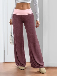Detail of wide pink fold-over waistband on burgundy wide-leg casual sports trousers