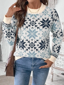 Detail of the blue and white snowflake pattern on a knit Christmas sweater with ribbed collar