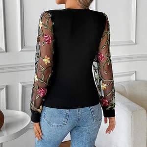 Women's V-neck top with floral embroidery and lace sleeves shown from a back view