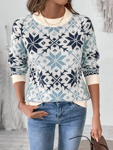 Close-up of winter knit sweater featuring vintage blue snowflake patterns and ribbed cuffs