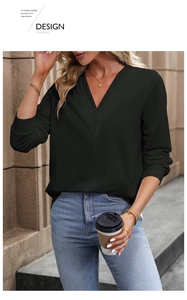 Detail of a chic black V-neck blouse featuring cuffed sleeves and a soft draped fabric texture