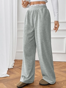 Detail of high waisted heather gray wide leg trousers with an elastic waistband design