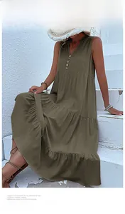 Detail of olive green V-neck dress with buttons and tiered skirt design