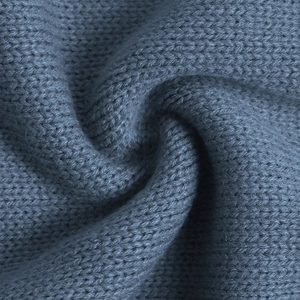 Detail shot of the high-quality dark blue ethnic knit fabric with soft wool texture