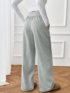 Rear view of high waist wide leg grey lounge pants with elastic waistband on a model
