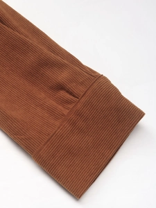Detailed close-up of brown corduroy sleeve cuffs showing fine texture and sewing