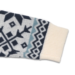 Detail of ribbed cuff and Nordic Fair Isle snowflake patterns on a knitted sweater