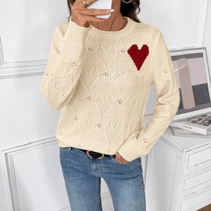 Women's loose cream knit sweater with hollow heart patterns and a red heart detail