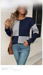 Detail of navy and grey patchwork textured knit fabric on a long-sleeve crewneck top