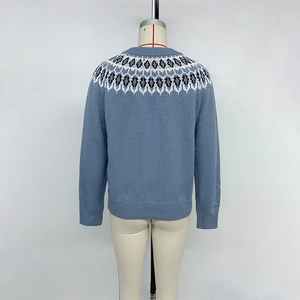 Women's blue Fair Isle pattern knit sweater with crew neck and ribbed cuffs on mannequin