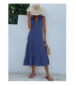 Detail of navy blue V-neck tiered maxi dress with buttons shown on a model outdoors