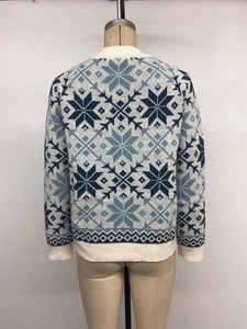 Detail of knitted snowflake pattern and geometric jacquard on Christmas sweater