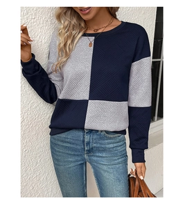 Detailed view of women's round neck sweatshirt featuring navy and grey color blocking