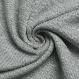 Macro shot of light gray knitted fabric texture with soft layered spiral structure