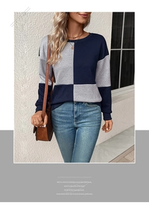 Close-up of color-block knit sweater texture with navy and grey contrast design