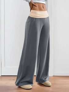 Detail of the elastic beige waistband on these high-waisted dark grey wide leg yoga pants