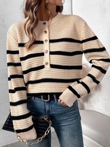 Detail of waffle-textured knit pattern and buttoned collar on a striped women's sweater