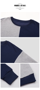 Macro view of textured geometric stripes and ribbed crew neck on color-block sweatshirt